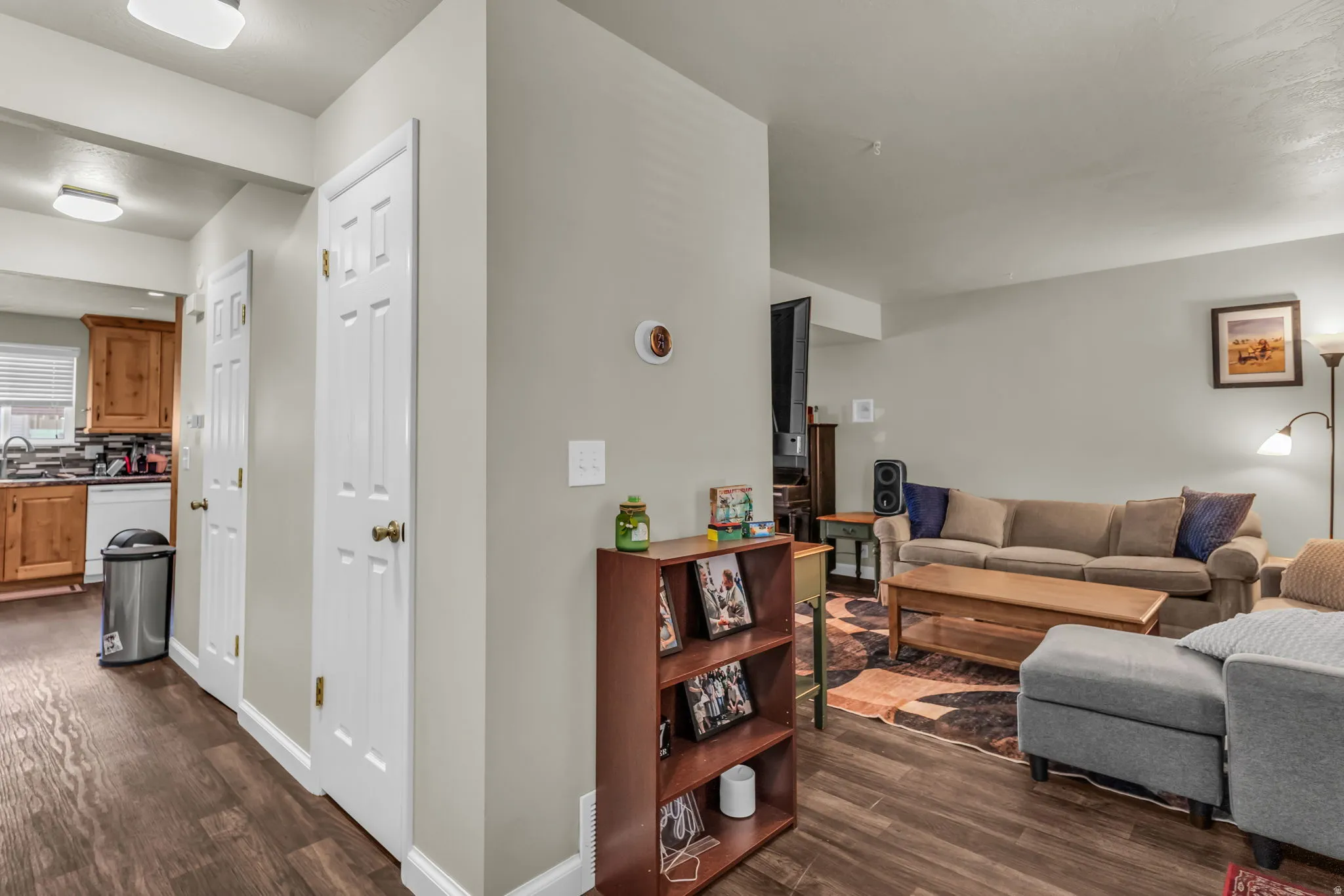 Open-concept living space featuring wood-finish flooring, neutral wall tones, and recessed lighting