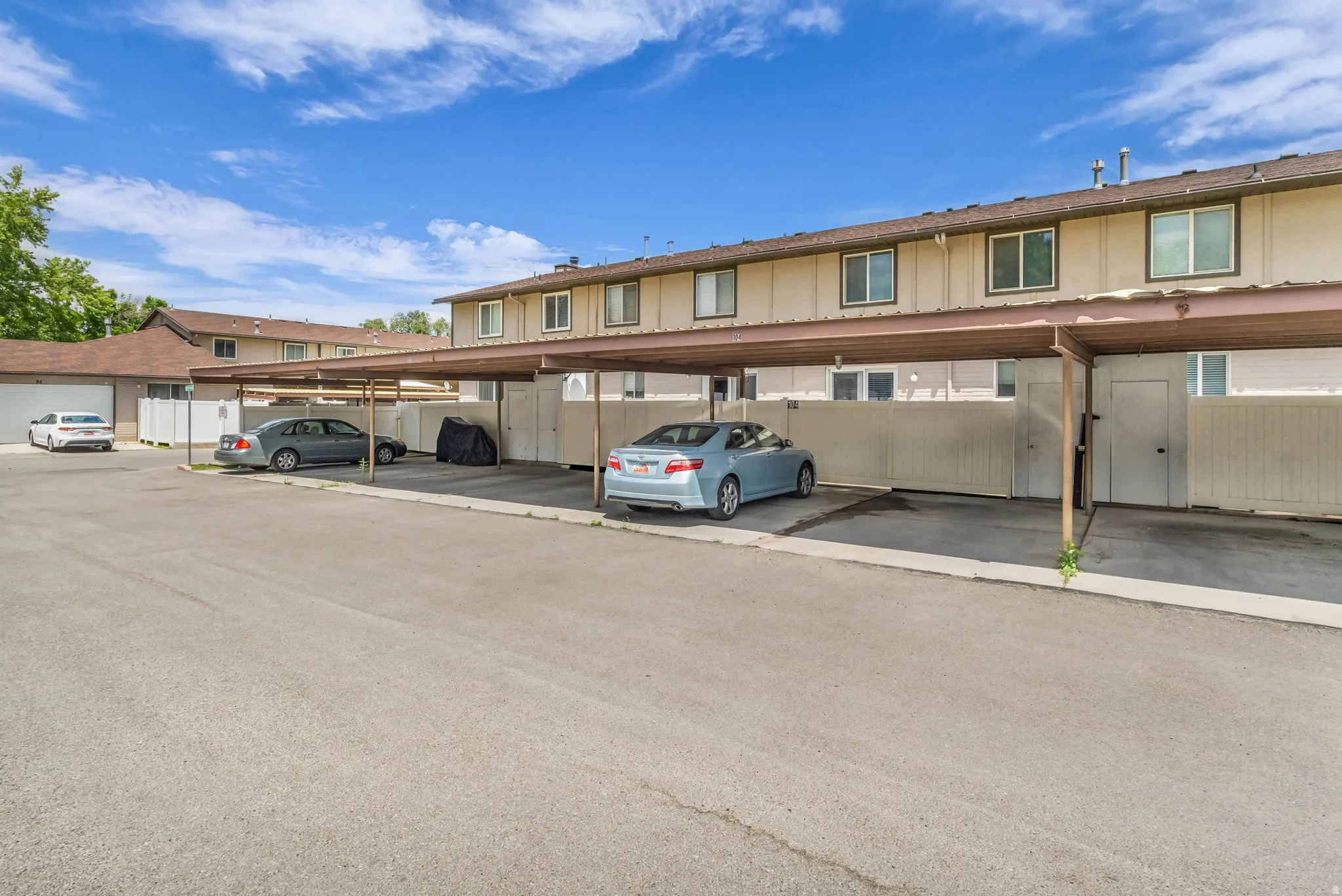 Covered parking structures providing sheltered vehicle storage