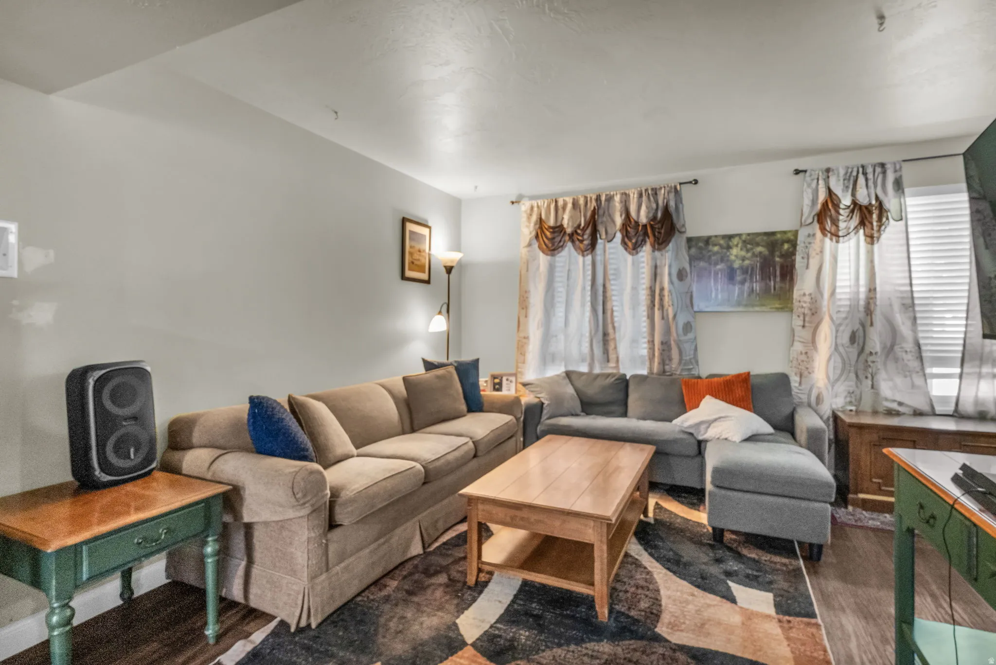 Living area featuring light gray wall paint and wood-finish flooring