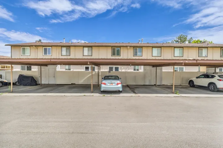 Covered parking structure with individual carport spaces