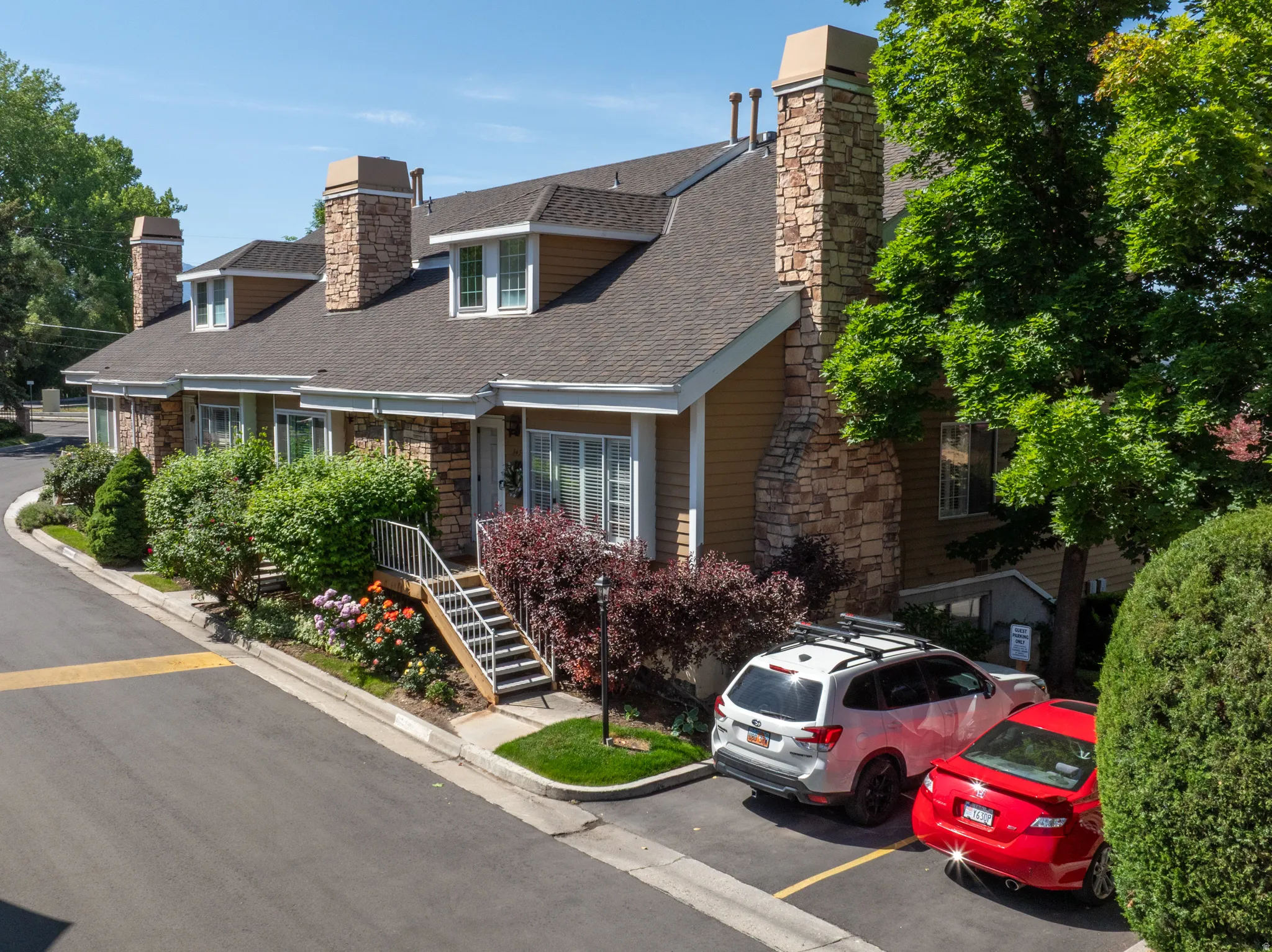 Multi-unit residence featuring stone veneer and horizontal siding