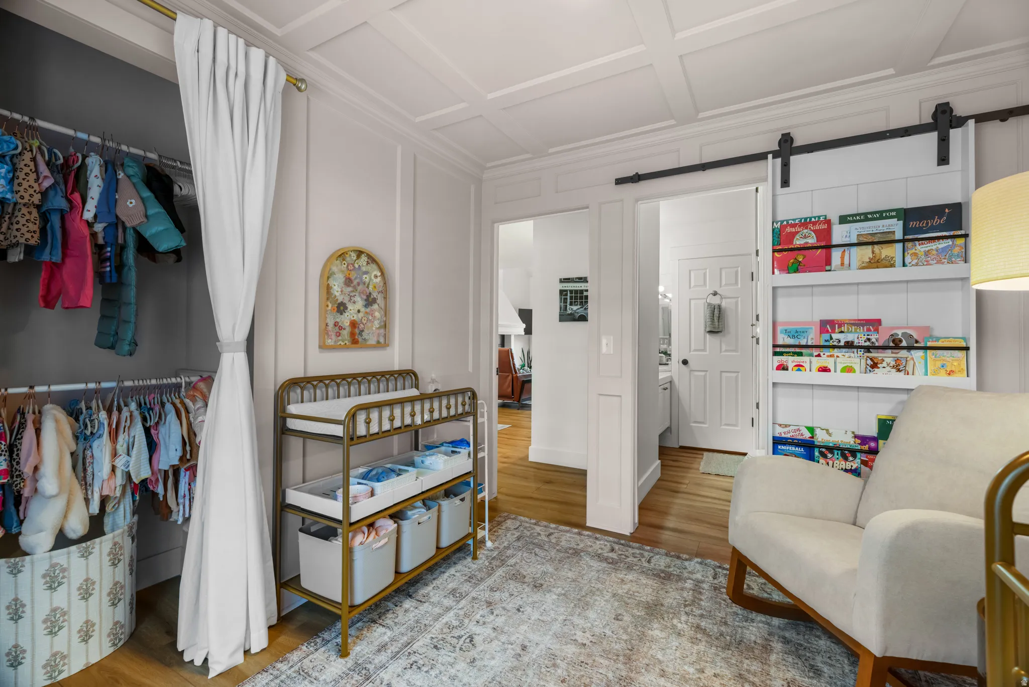 White paneled walls with crown molding and a coffered ceiling