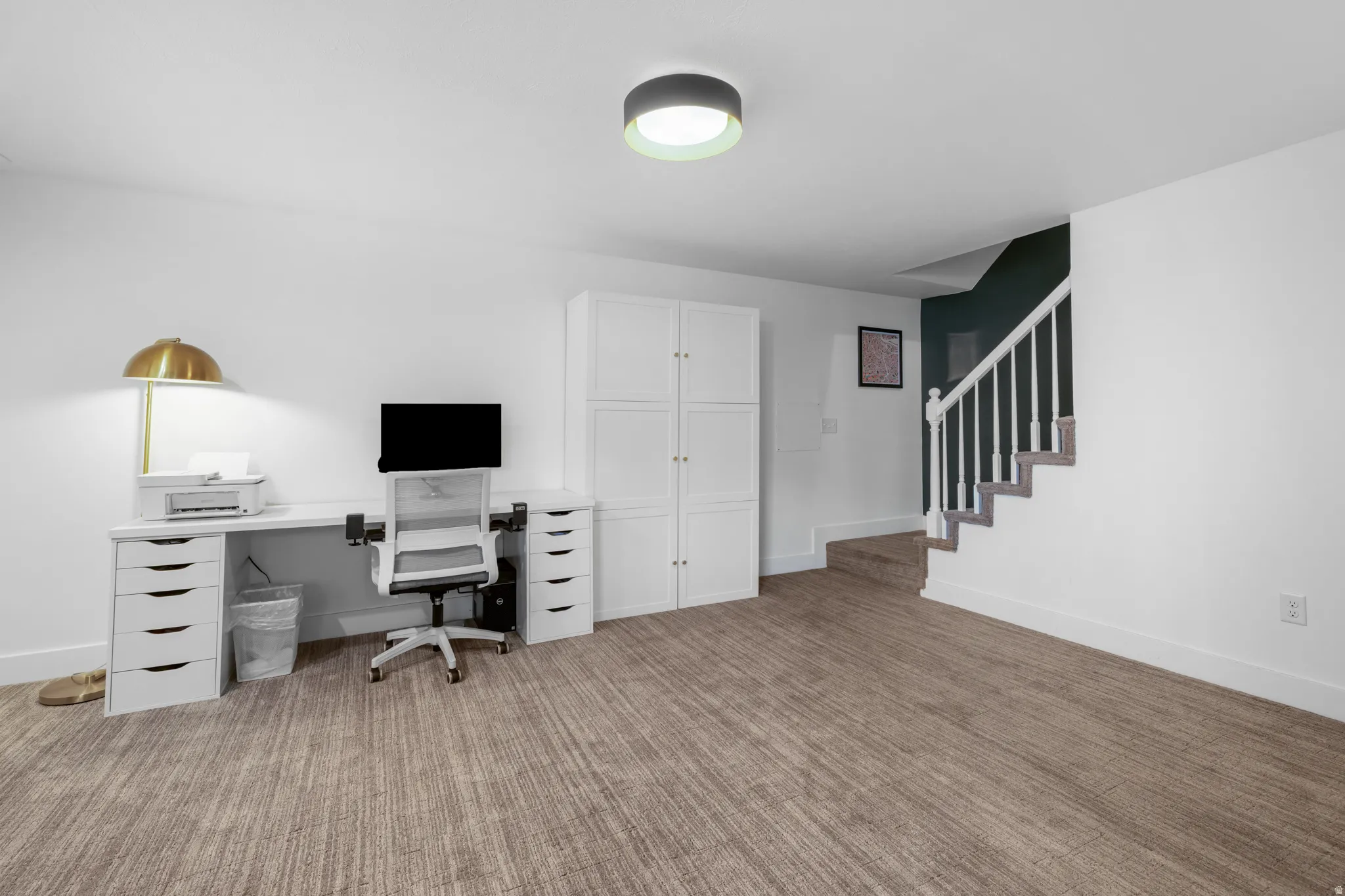 Versatile open-concept room with neutral-toned carpeted flooring, white baseboards, and a contemporary flush-mount ceiling light