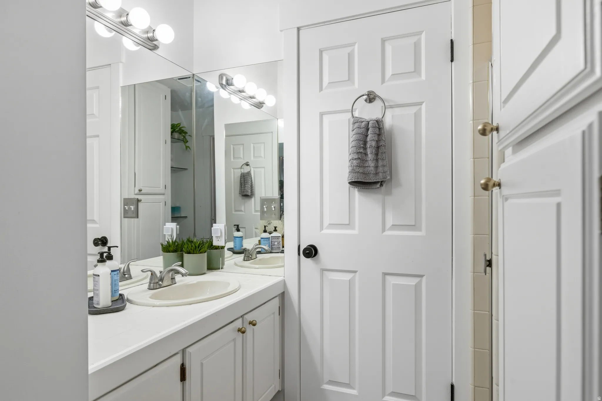 White vanity with dual integrated sinks and polished chrome fixtures