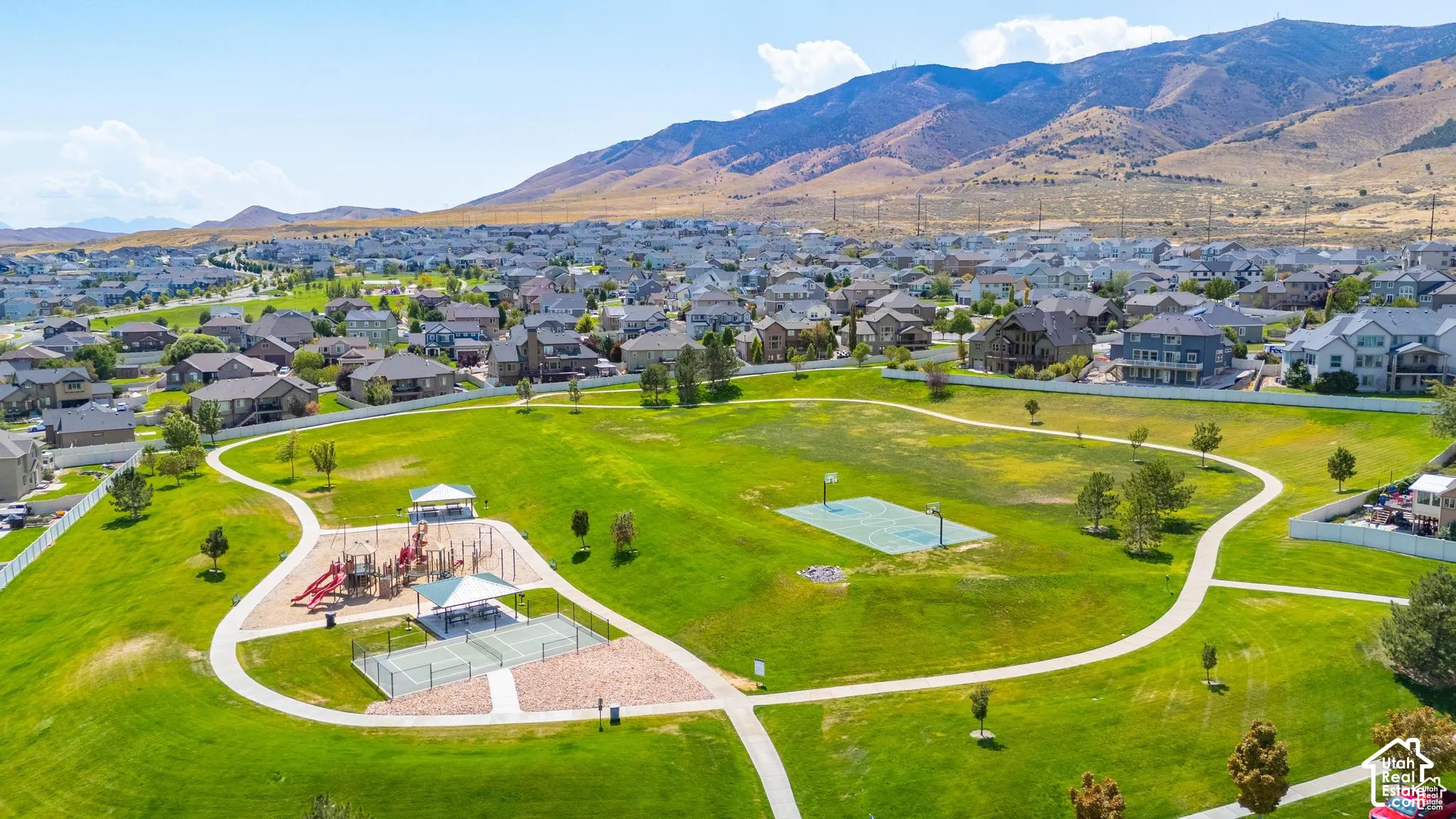 Community park featuring a huge playground, pickleball & basketball courts, and winding pathways