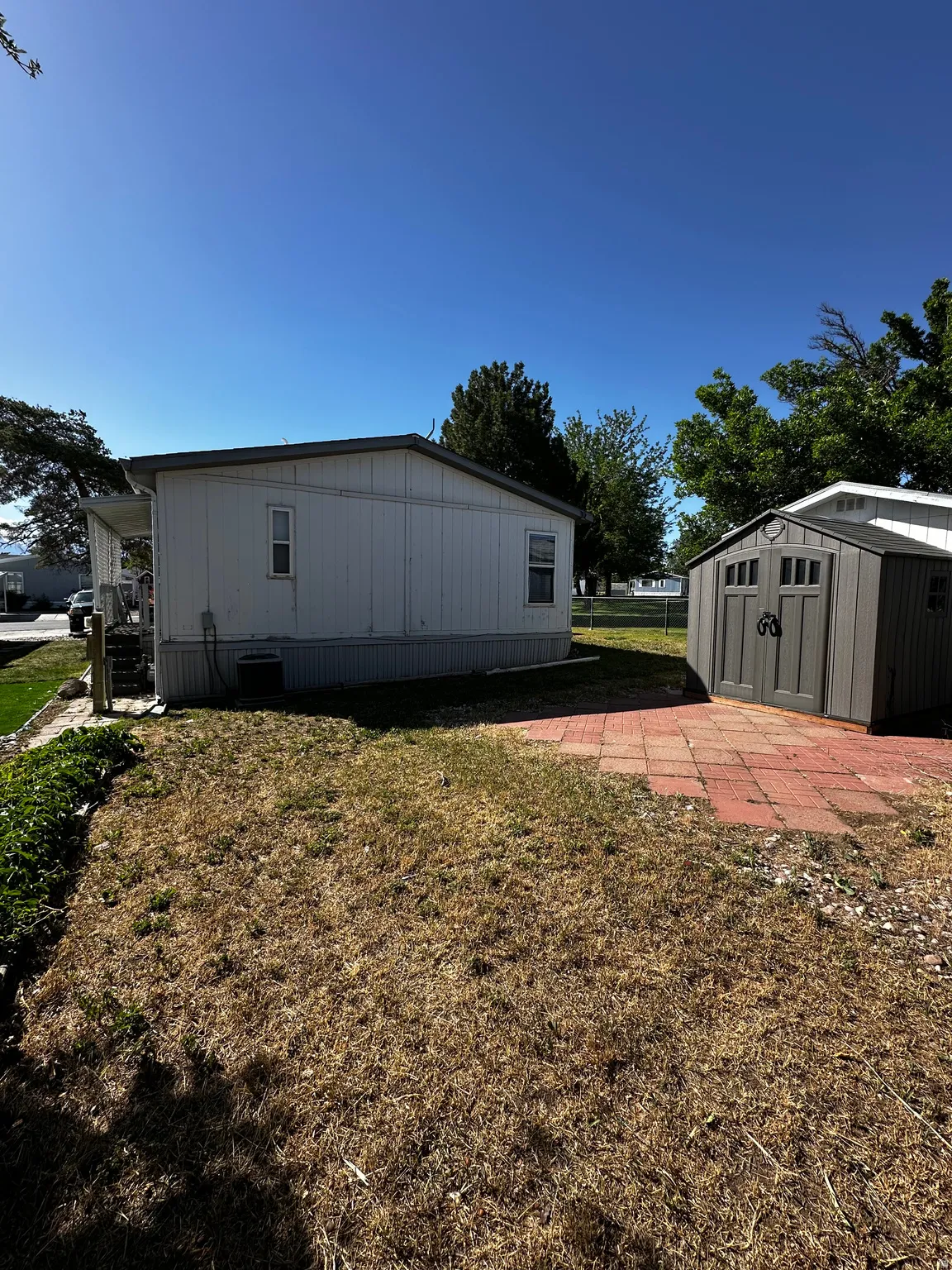 Detached storage shed with a gabled roof and double doors