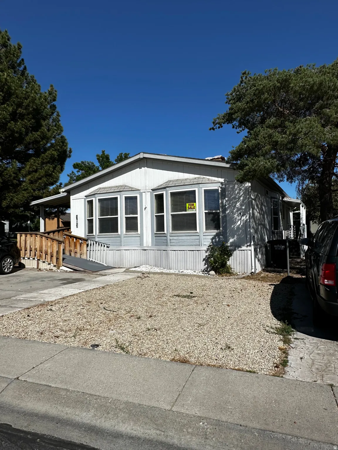 White siding exterior with a light blue accent panel and white trim