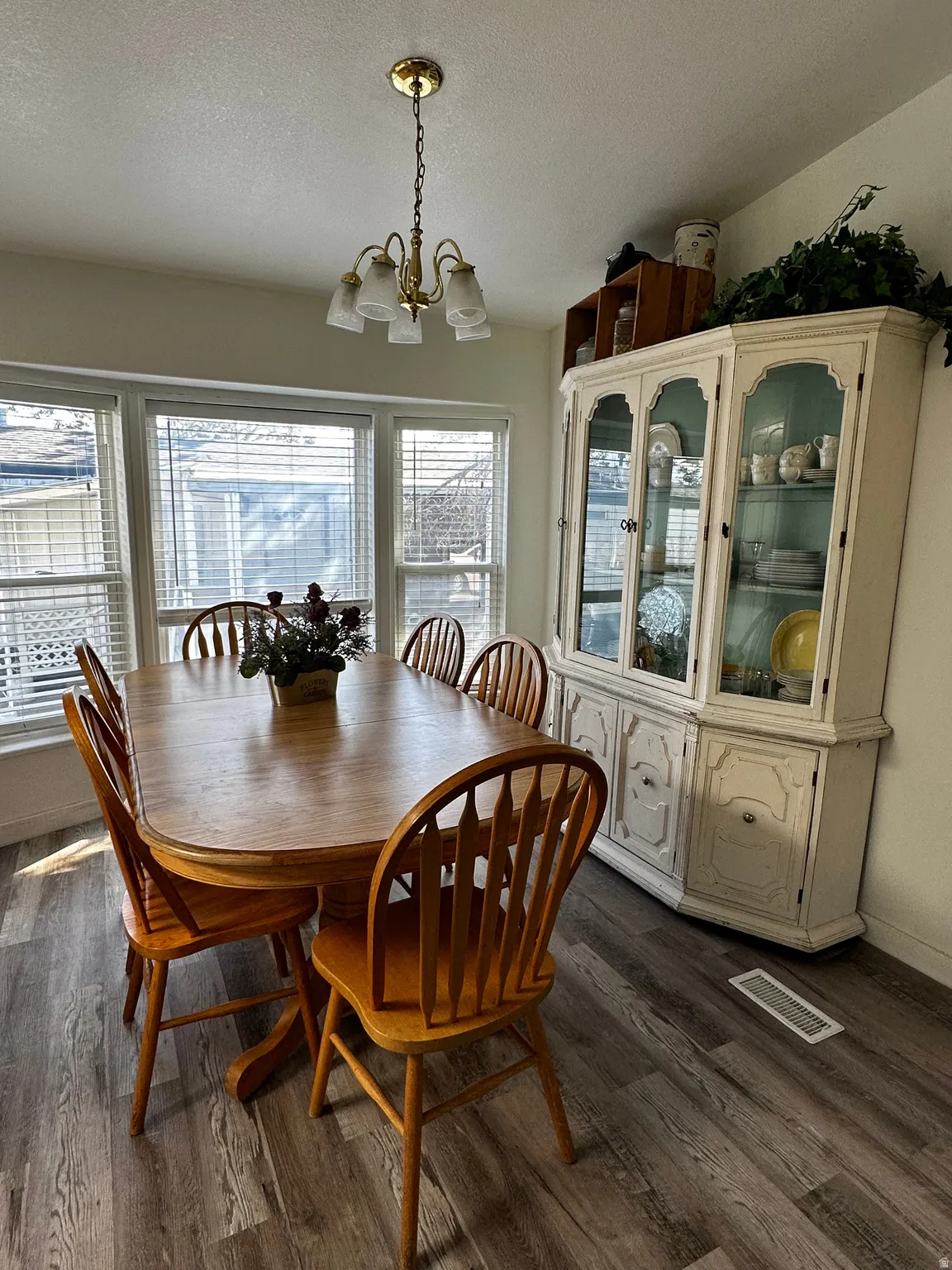 Dining area featuring wood-finish flooring and a multi-pane window