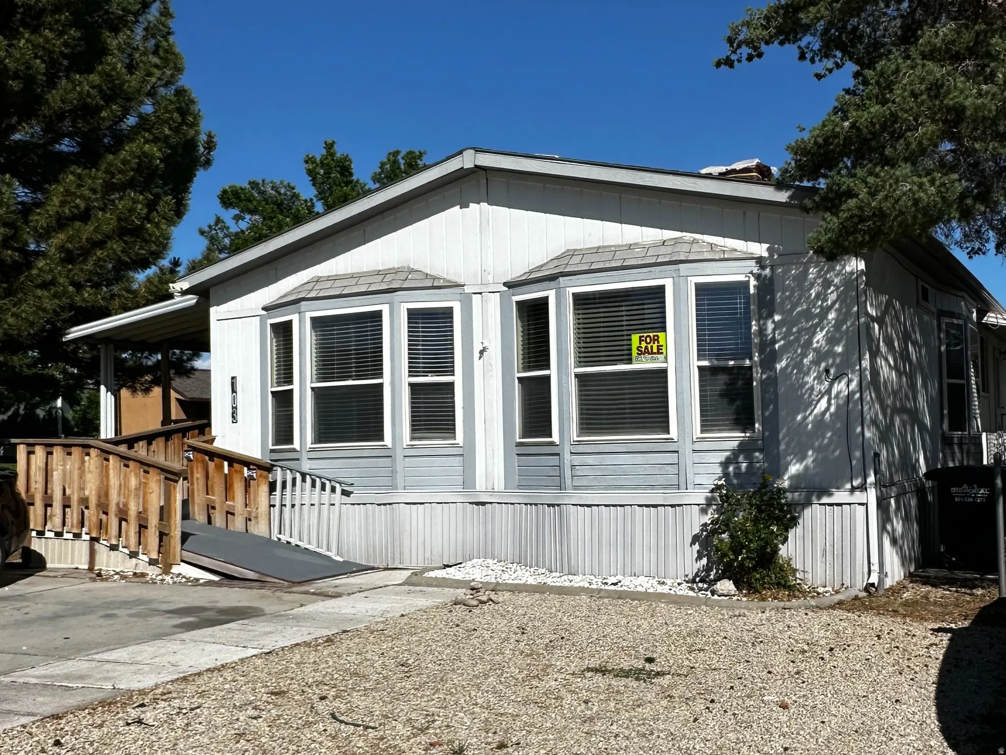 White siding exterior with a light blue accent panel and white trim