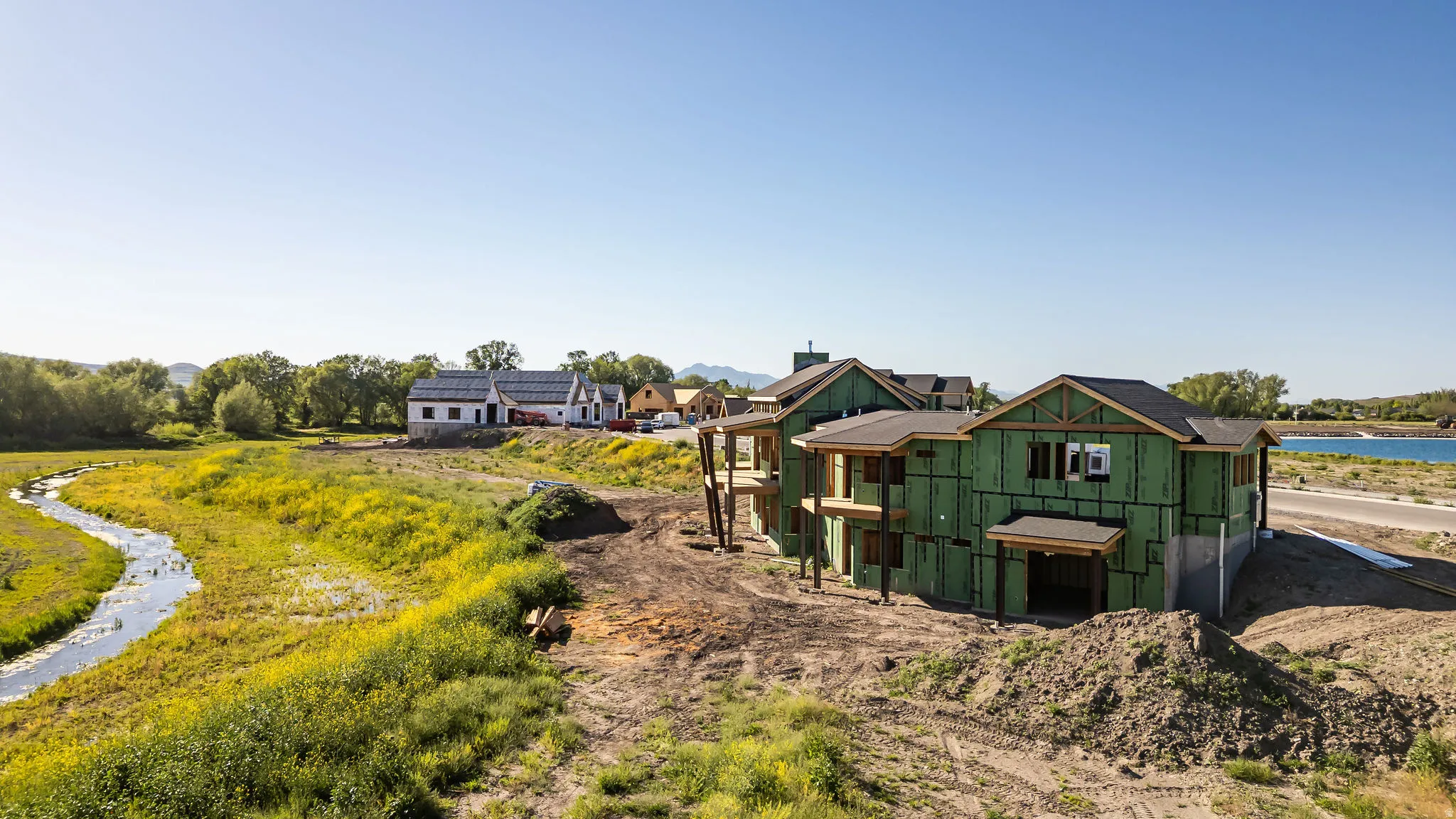 New construction property featuring a two-story design with prominent gables and a dark shingle roof