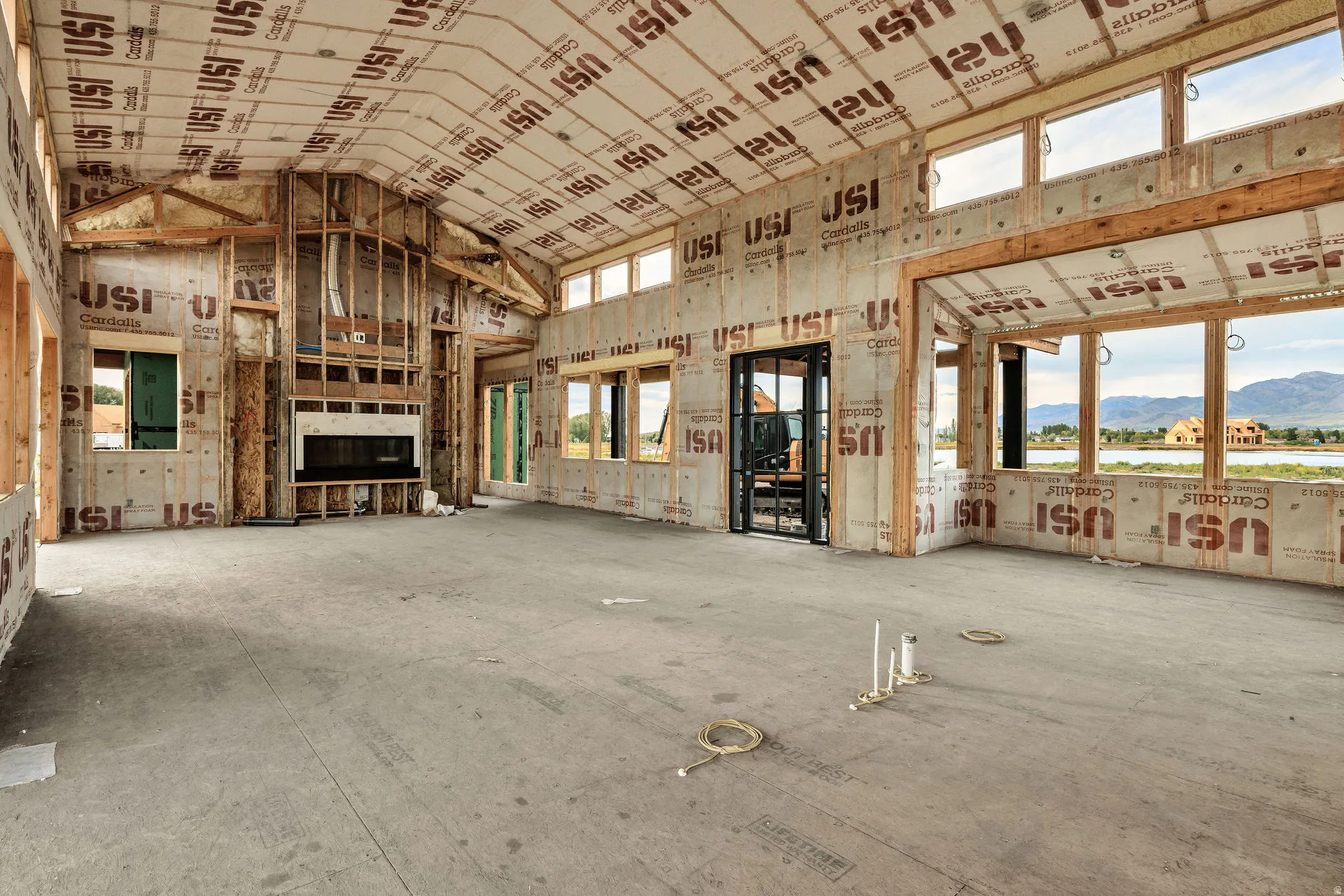 Spacious open-concept interior featuring vaulted ceilings and abundant natural light
