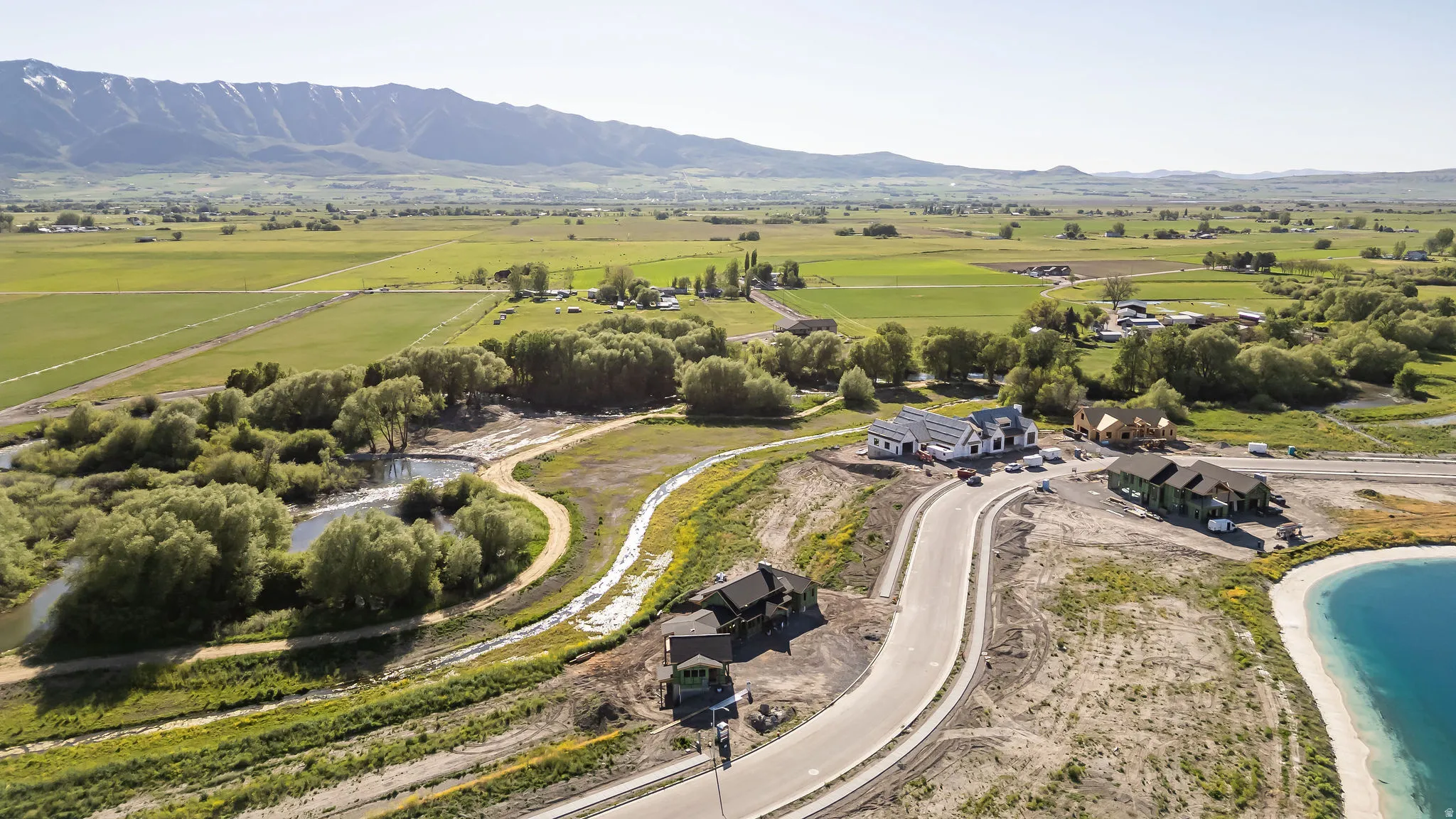 Expansive rural landscape featuring distant mountains and verdant fields
