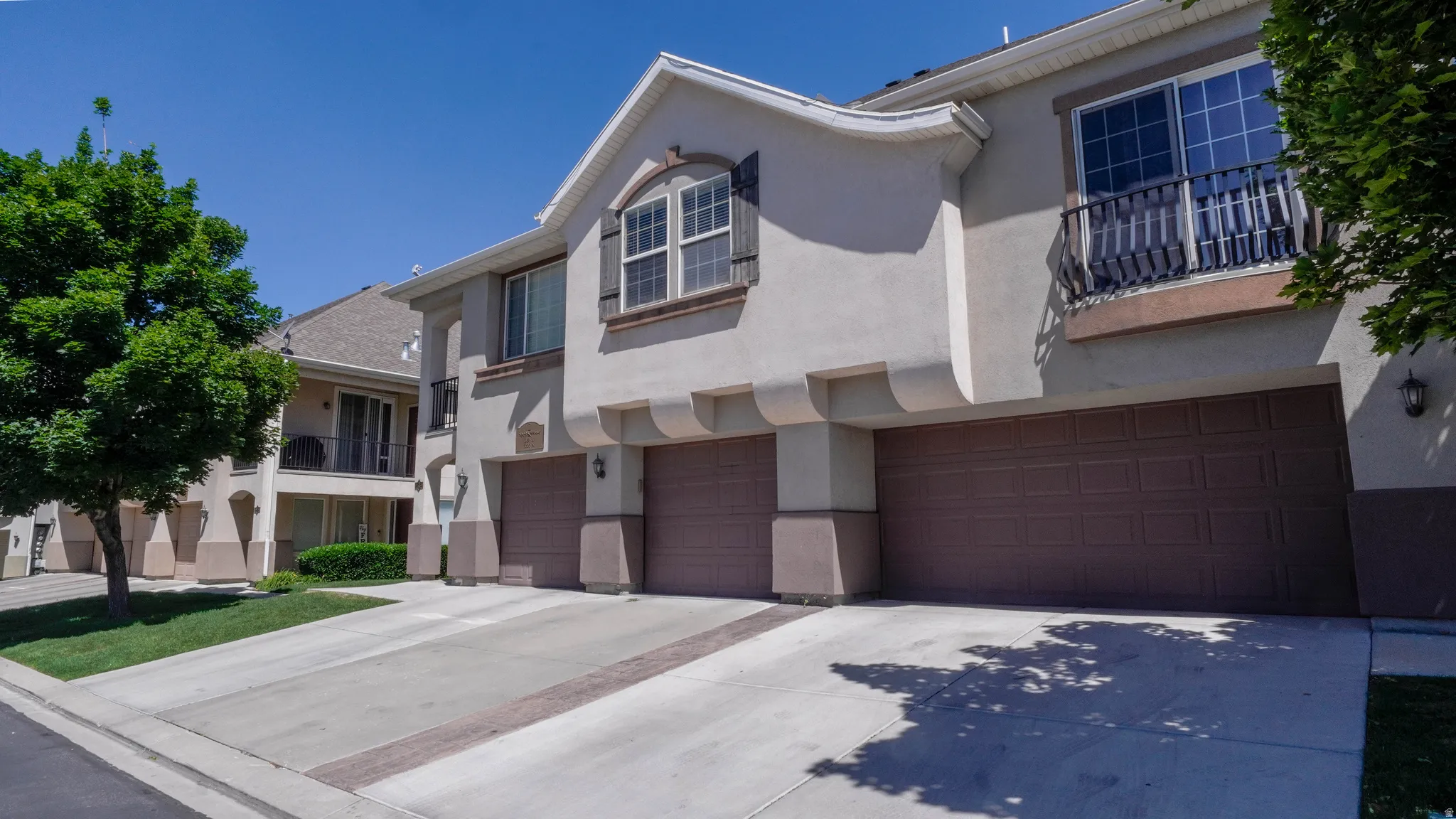 Stucco exterior with multiple attached garage doors