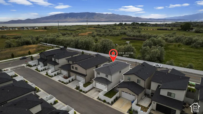 Modern residential development featuring multi-story townhomes with dark shingle roofs