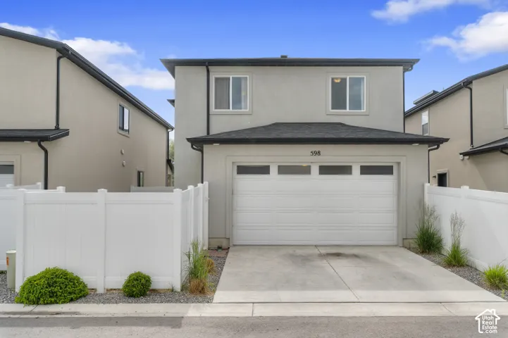 Stucco exterior with a two-story design and an attached garage