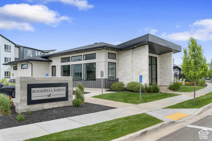 Modern building exterior featuring a mixed material facade with light-colored stone and dark horizontal siding