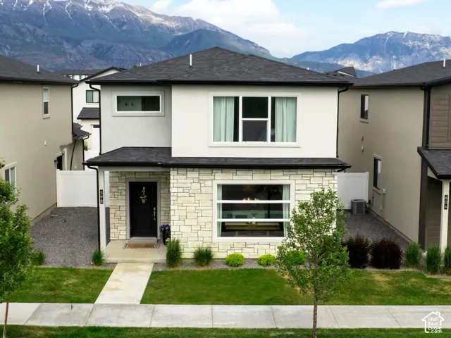 Contemporary exterior with light stucco and stone accents