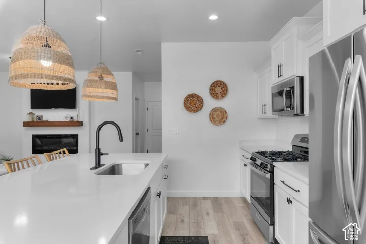 Modern kitchen featuring a large island with an undermount sink and black faucet