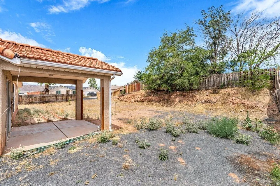 Covered patio with a concrete slab, red tile roof, and integrated gutter system