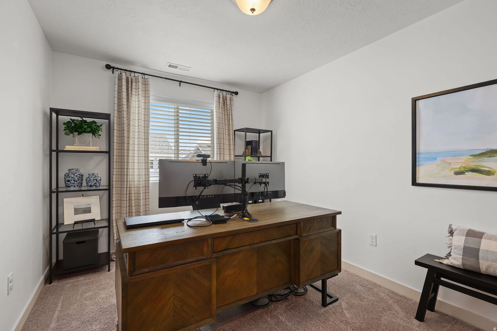 Neutral-toned room featuring a window with blinds and drapes, light-colored walls, and carpet flooring