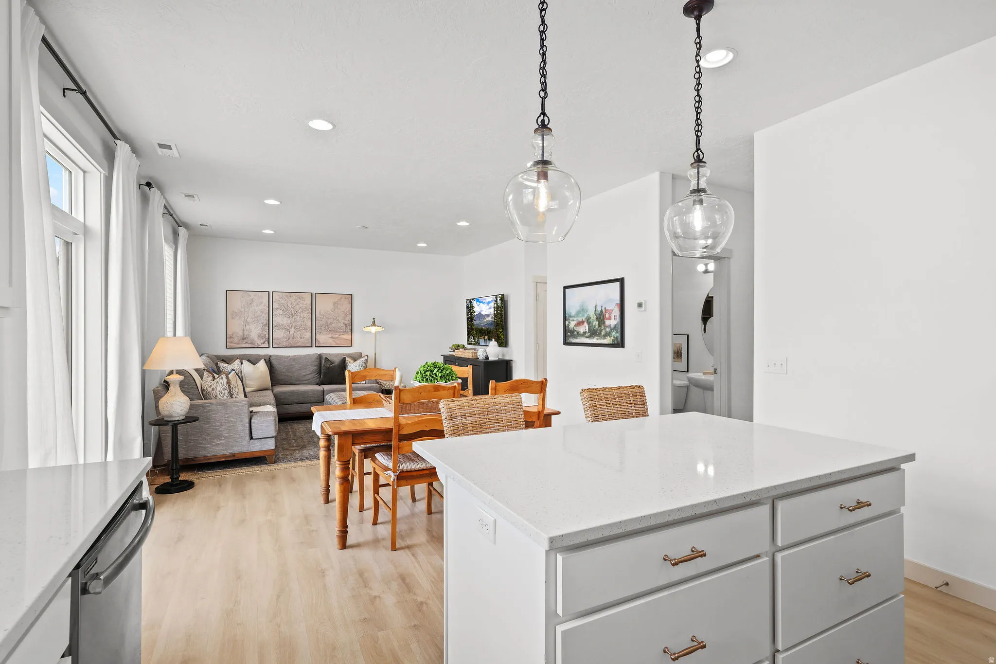 Kitchen island with a white countertop and brass hardware