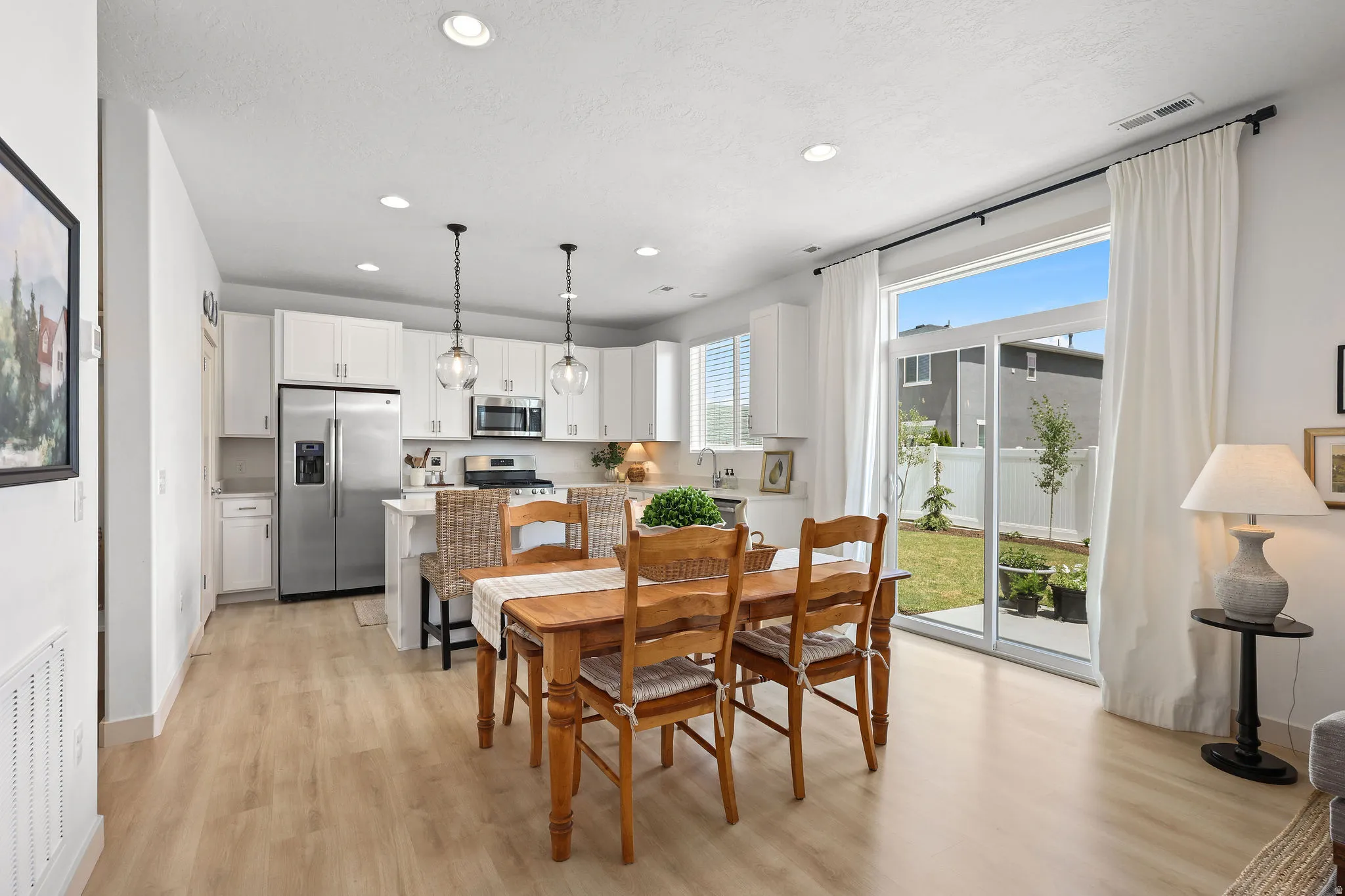 Open-concept space featuring wood-finish flooring, recessed lighting, and a modern kitchen