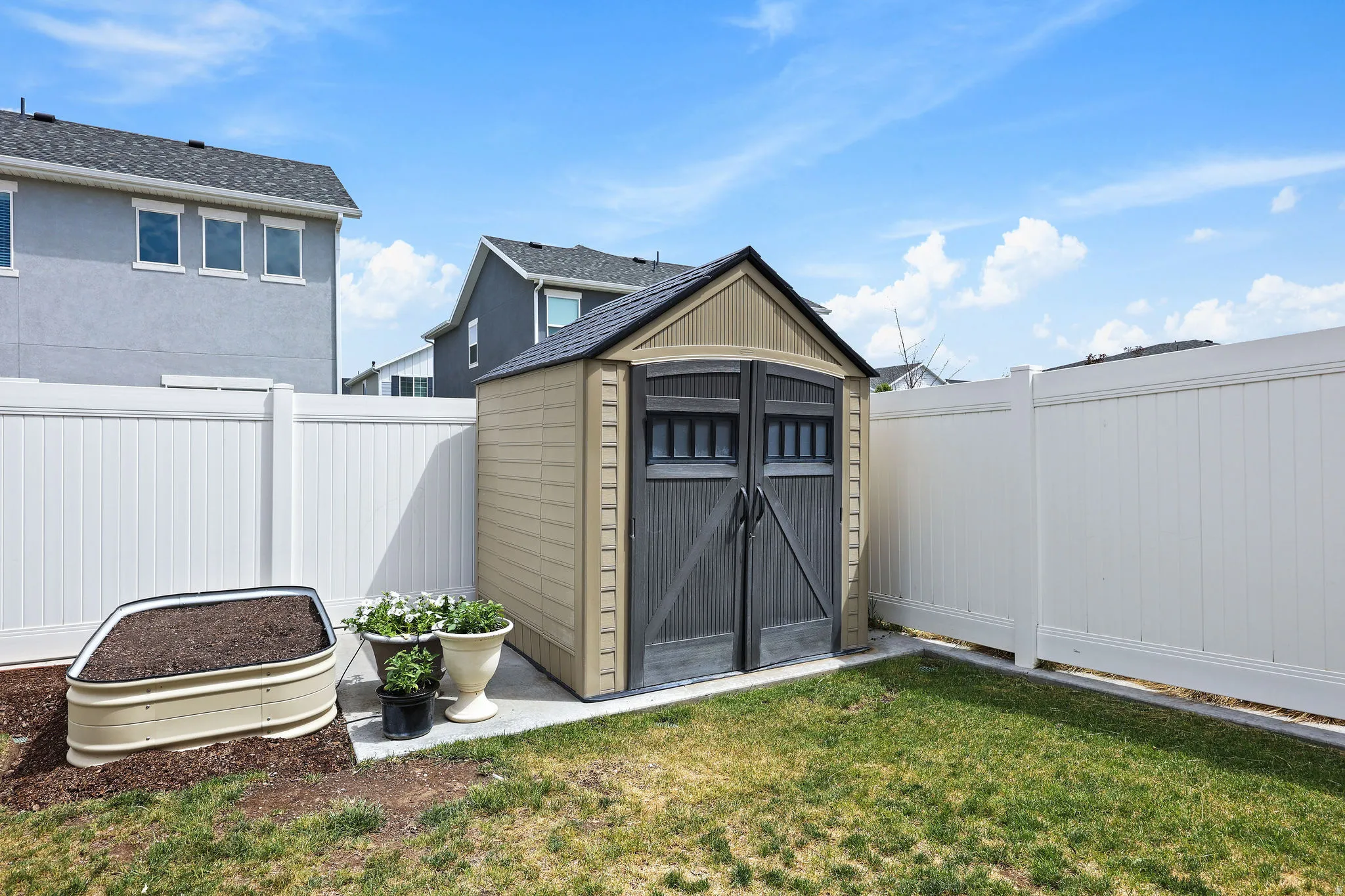 Storage shed with double doors situated on a concrete pad