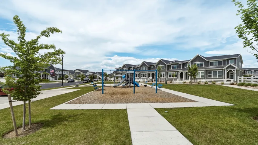 Community playground featuring a swing set and slide structure