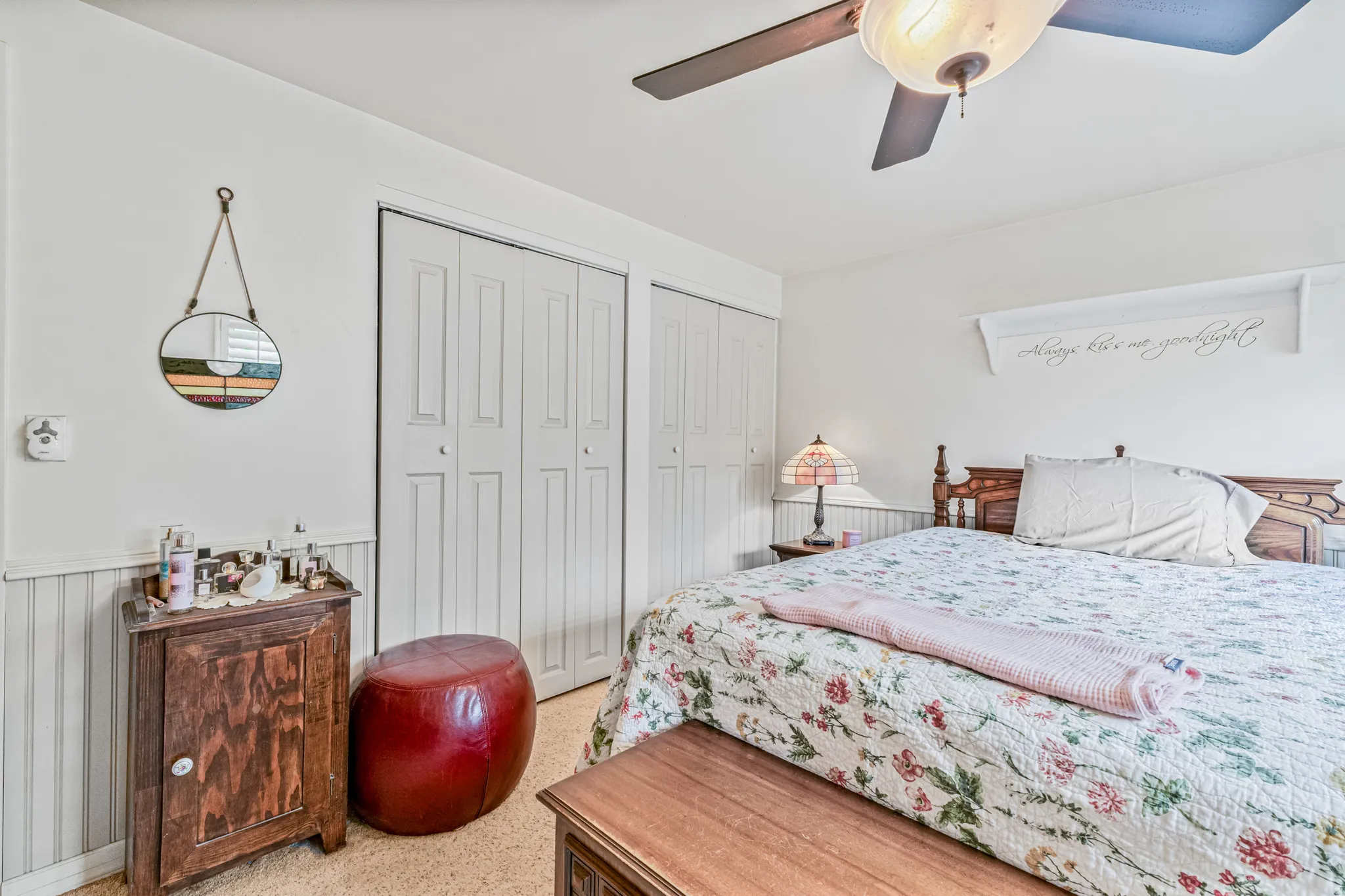 White walls with wainscoting and a wood-finish floor