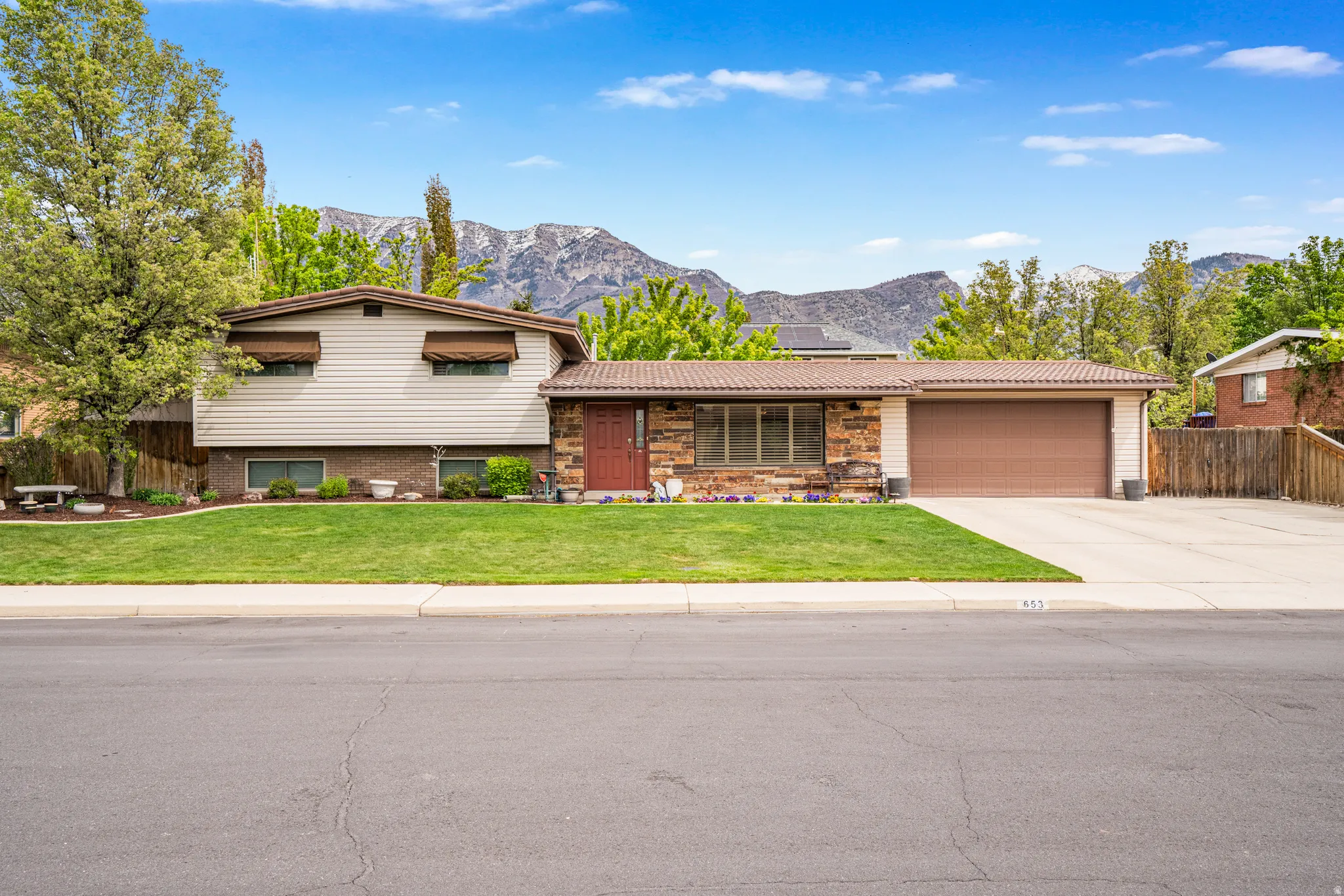 Front exterior showcasing a multi-level design with a stone accent facade