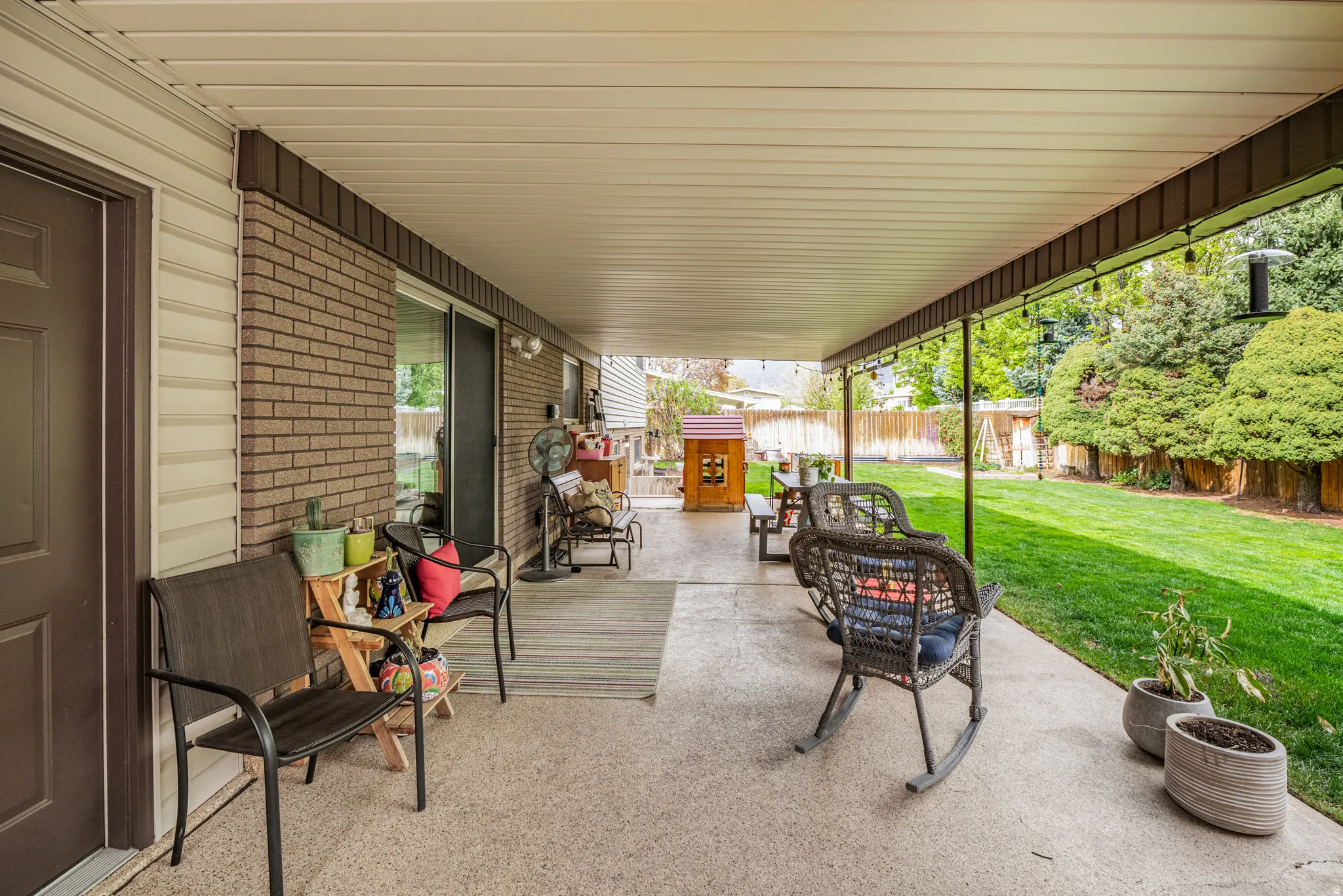 Expansive covered patio featuring a concrete surface and direct access to the backyard