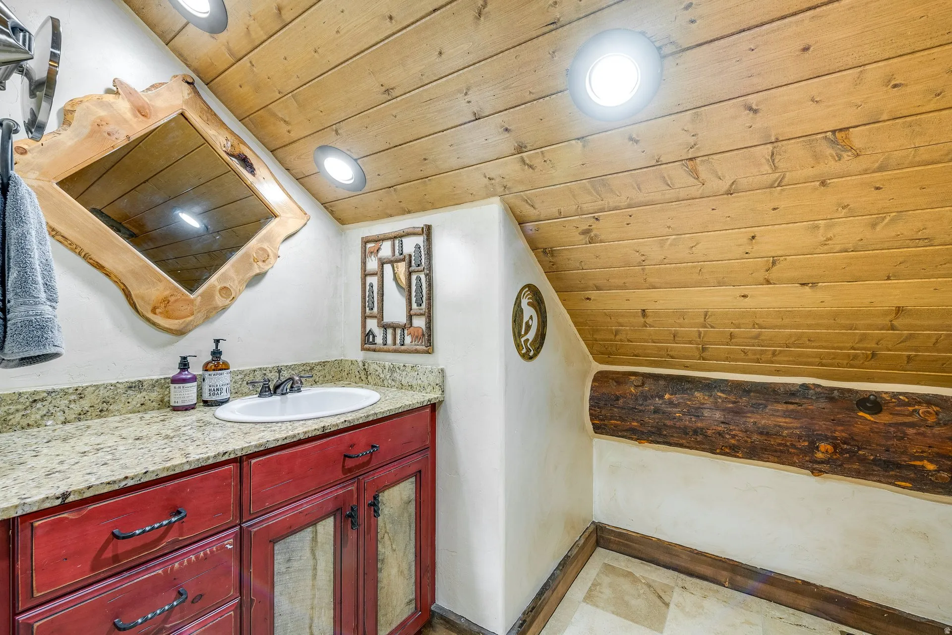 Powder room featuring a wood-plank ceiling, recessed lighting, a log beam accent, a vanity with a granite countertop, and a vessel sink