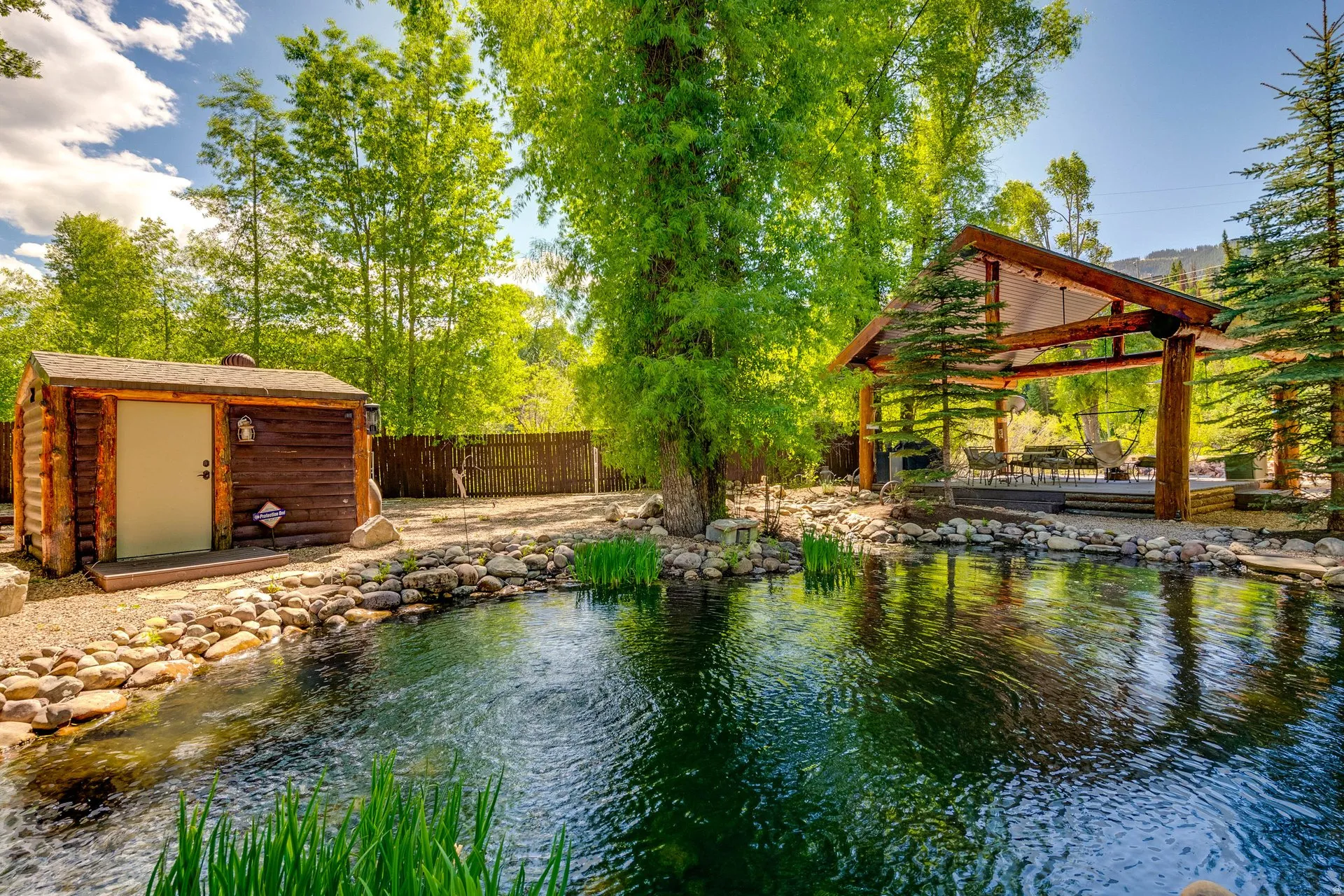Natural water feature with surrounding rock landscaping