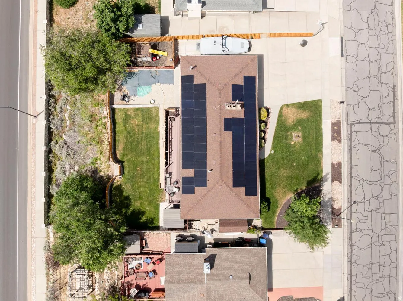 Brown shingled roof featuring extensive solar panel installations