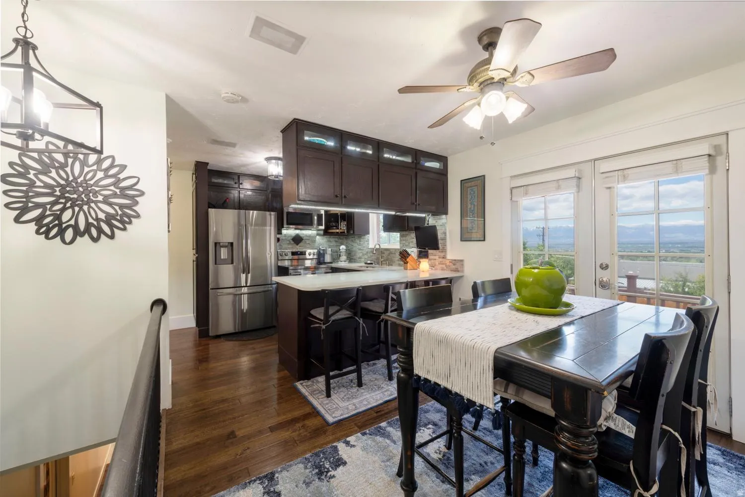 Open-concept kitchen and dining area featuring rich wood-finish flooring