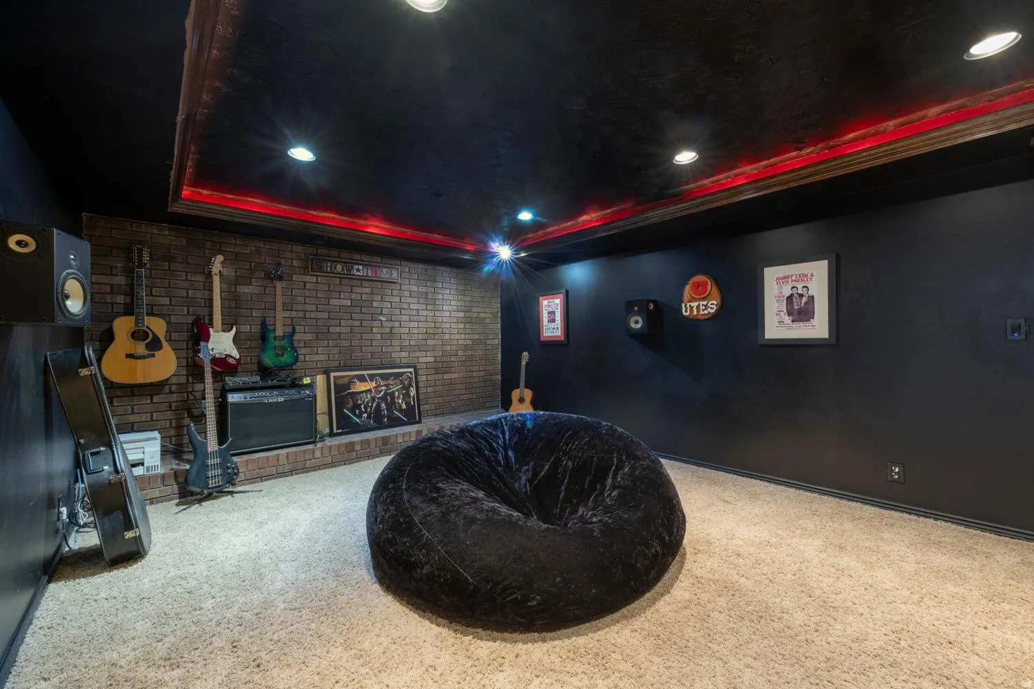 Entertainment room featuring a brick accent wall and recessed lighting