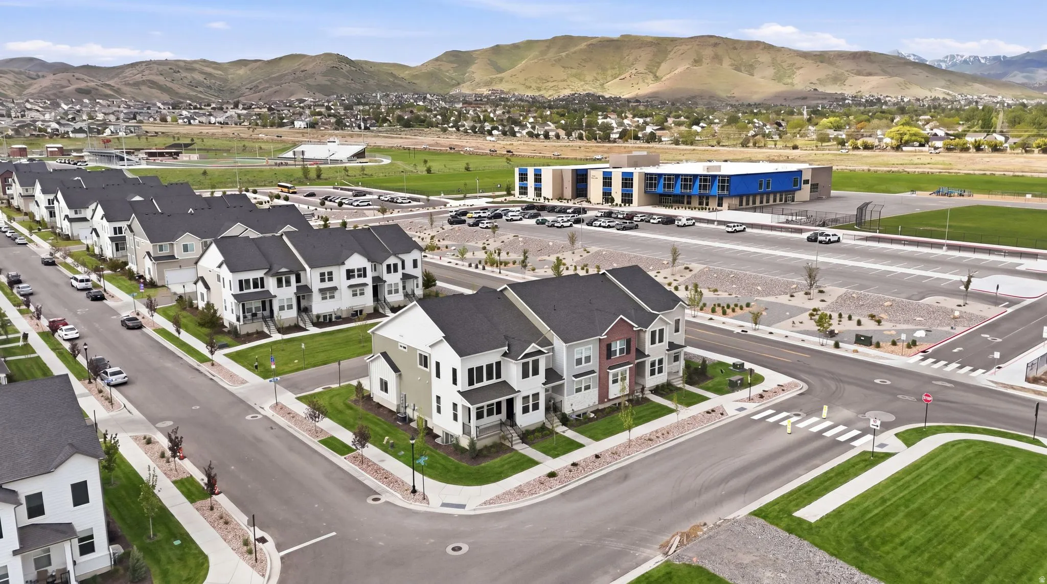 Contemporary residential development featuring multi-story townhomes with varying facade colors