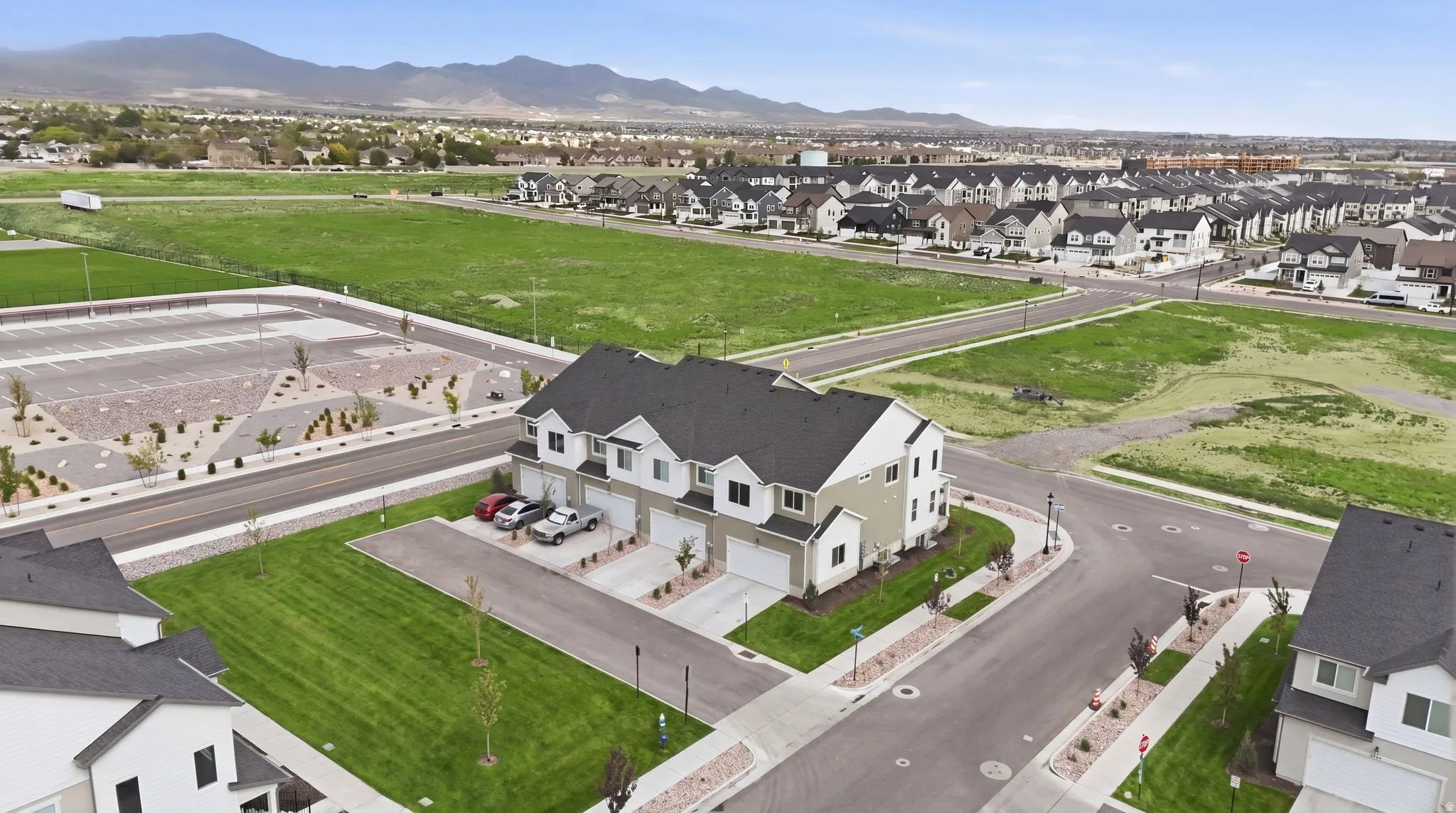 Modern townhome community featuring a neutral color palette, attached garages, and manicured landscaping