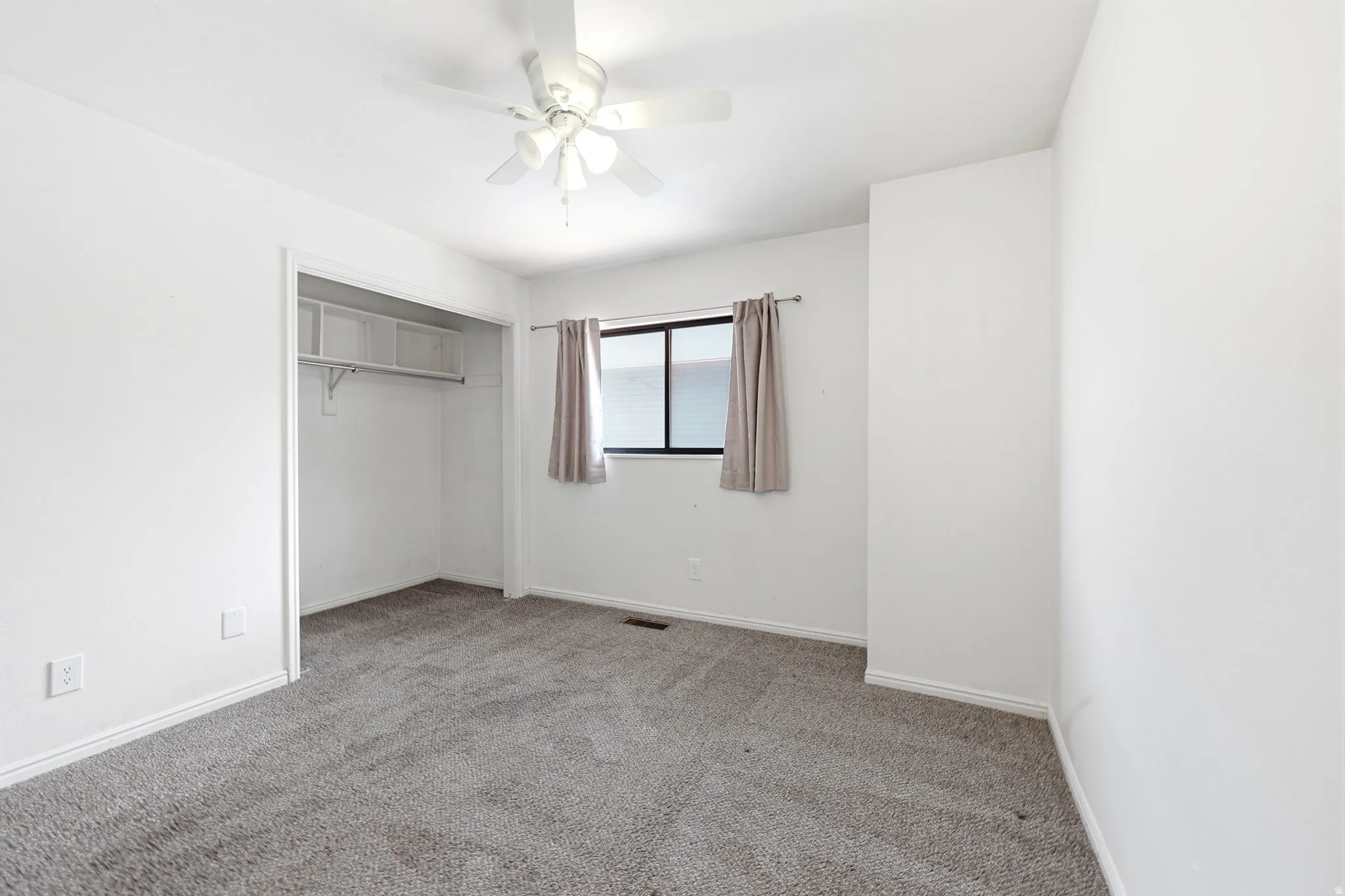 Bedroom featuring gray carpeting and white painted walls