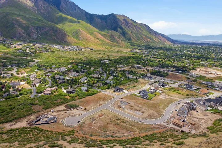 Expansive land parcel featuring new road infrastructure and several properties under construction