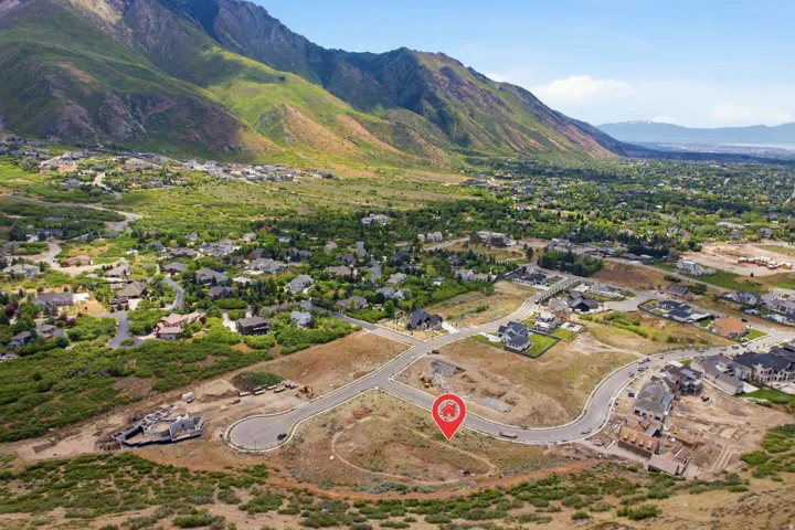 Expansive land parcel featuring existing paved roadways and partial mountain scenery