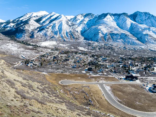Expansive land parcel featuring paved road access, a cul-de-sac, and surrounding residential development