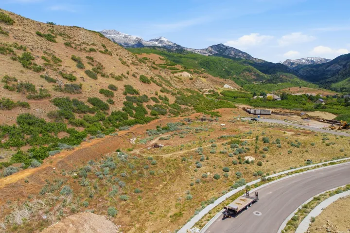 Unimproved land parcel featuring mountain scenery and partial road frontage