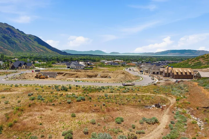Developing residential area with visible mountains and a distant body of water