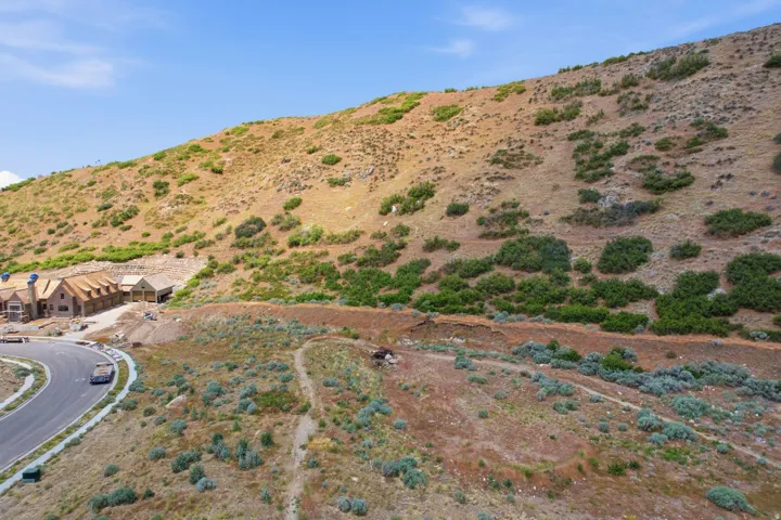 Hillside property featuring natural terrain and sparse vegetation