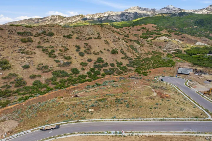 Expansive mountain landscape featuring varied terrain and a paved roadway
