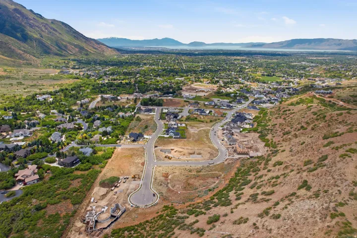 Expansive aerial perspective showcasing a developing residential area with paved streets and new home construction