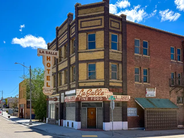 Historic mixed-use building featuring brick construction and prominent signage
