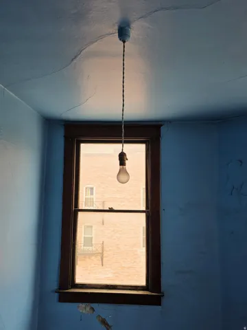 Single-pane window with dark wood trim, providing natural light