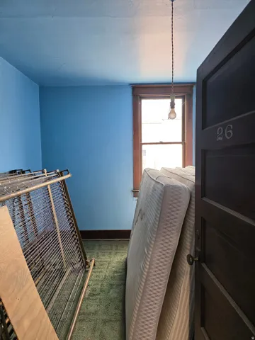Room with blue-painted walls and green carpet flooring